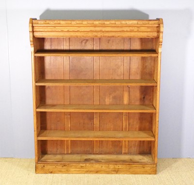 Lot 722 - A pitch pine freestanding open bookshelf, with...