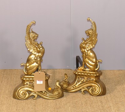 Lot 729 - A pair of polished brass fire dogs, each in...