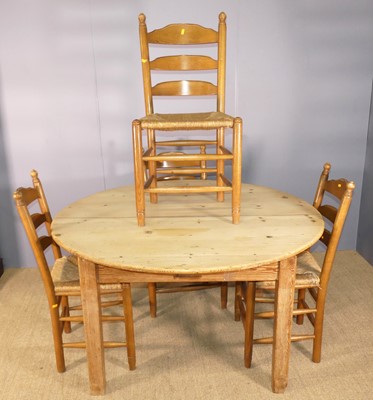 Lot 730 - A rustic pine circular farmhouse kitchen table,...