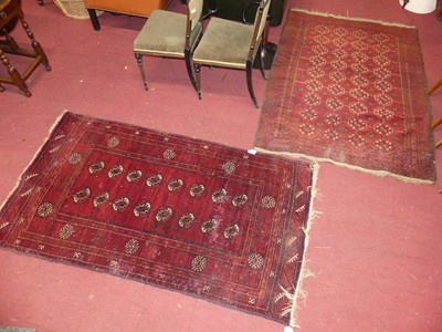 Lot 741 - A Persian red ground woollen Bokhara rug with...