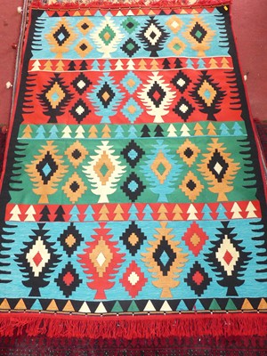 Lot 748 - A bright coloured Afghan kilim flat weave rug,...