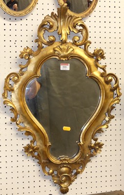 Lot 599 - A floral scroll carved and pierced giltwood...