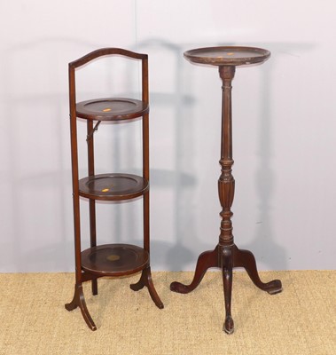 Lot 610 - A mahogany circular three-tier folding cake...