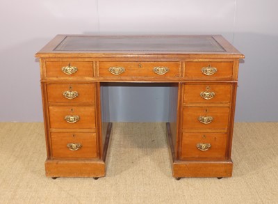 Lot 624 - An Edwardian walnut twin-pedestal writing desk,...