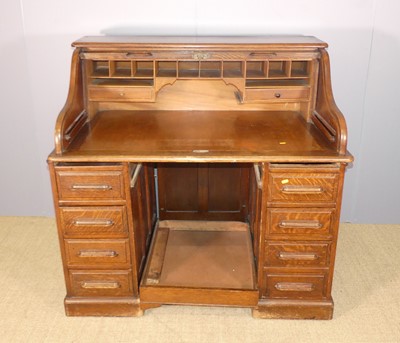 Lot 626 - A 1930s oak pedestal rolled top desk, w.121.5cm