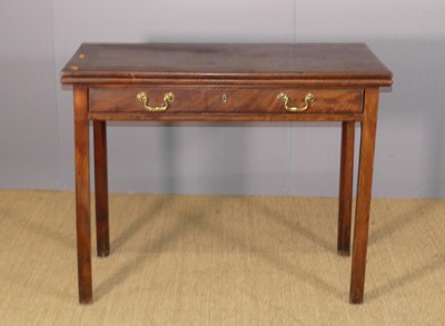 Lot 635 - A George III mahogany fold-over tea table,...