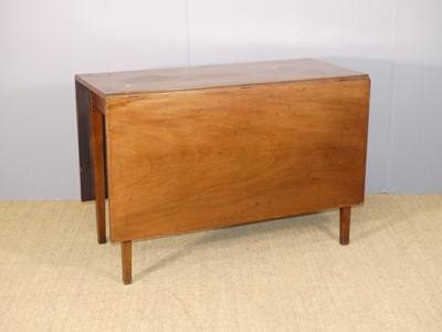 Lot 636 - A George III mahogany drop-leaf dining table,...