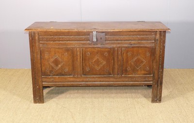 Lot 637 - An antique joined oak hinge-top three-panel...