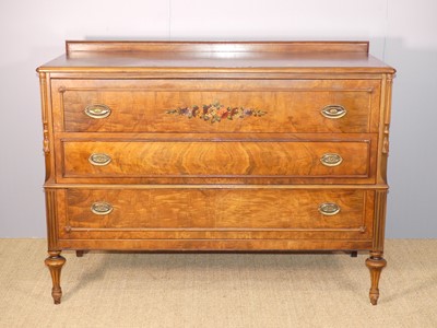 Lot 638 - A French-style walnut three-drawer commode, by...