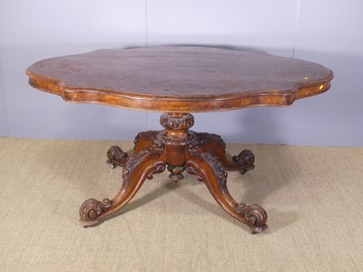 Lot 653 - A mid-Victorian figrued walnut shaped top...