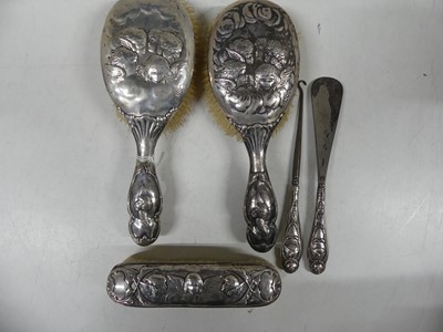 Lot 296 - An Art Nouveau five-piece silver-backed...