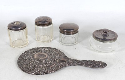 Lot 285 - Four George V silver topped dressing jars, to...