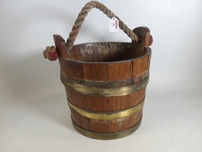 Lot 56 - A coopered wooden bucket, with rope handle,...