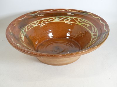 Lot 64 - A Spanish slip-glazed terracotta lebrillo bowl,...