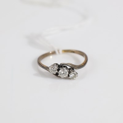 Lot 322 - An 18ct gold diamond three-stone ring, the...