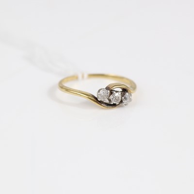 Lot 334 - An 18ct gold diamond three-stone ring, the...