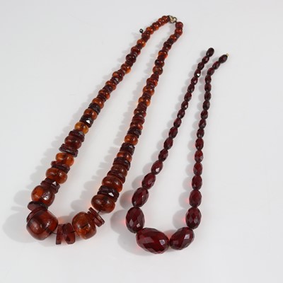 Lot 381 - A beaded clear orange amber necklace, 50cm;...